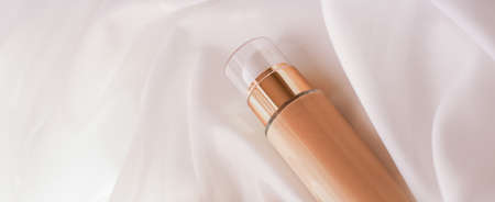 Cosmetic branding, glamour and skincare concept - Tonal bb cream bottle make-up fluid foundation base for nude skin color on silk background, cosmetics product as luxury beauty brand holiday designの写真素材