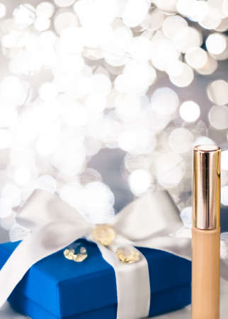 Cosmetic branding, Christmas glitter and girly blog concept - Holiday make-up foundation base, concealer and blue gift box, luxury cosmetics present and blank label products for beauty brand designの写真素材