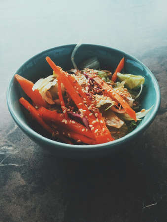 Vegan dieting, eating out and oriental cuisine concept - Vegetarian asian vegetable salad served in a bowl in japanese restaurant, healthy diet foodの写真素材