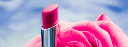 Cosmetic branding, luxe and fashion concept - Pink lipstick and rose flower on liquid background, waterproof glamour make-up and lip gloss cosmetics product for luxury beauty brand holiday designの写真素材