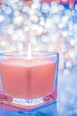 Festive decoration, branding and aromatherapy spa concept - Coral aromatic candle on Christmas and New Years glitter background, Valentines Day luxury home decor and holiday season brand designの写真素材