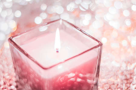 Festive decoration, branding and aromatherapy spa concept - Rose aromatic candle on Christmas and New Years glitter background, Valentines Day luxury home decor and holiday season brand designの写真素材