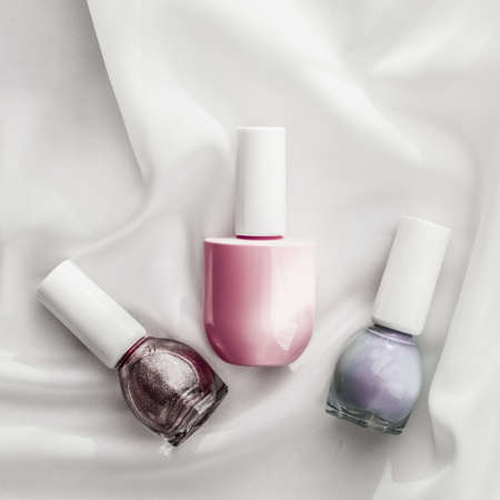 Cosmetic branding, salon and glamour concept - Nail polish bottles on silk background, french manicure products and nailpolish make-up cosmetics for luxury beauty brand and holiday flatlay art designの写真素材