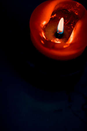 Happy holidays, greeting card backdrop and winter season concept - Red holiday candle on dark background, luxury branding design and decoration for Christmas, New Years Eve and Valentines Dayの写真素材