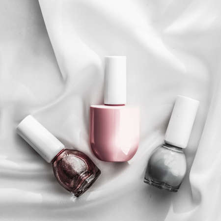 Cosmetic branding, salon and glamour concept - Nail polish bottles on silk background, french manicure products and nailpolish make-up cosmetics for luxury beauty brand and holiday flatlay art designの写真素材