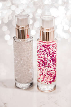 Cosmetic branding, blank label and glamour present concept - Holiday make-up base gel, serum emulsion, lotion bottle and silver glitter, luxury skin and body care cosmetics for beauty brand adsの写真素材