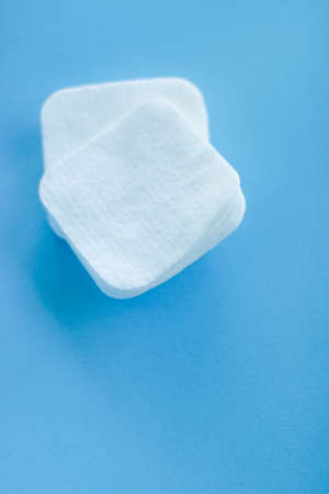 Cosmetology, cleanliness and branding concept - Organic cotton pads on blue background, cosmetics and make-up remover, hygiene and skincare beauty brand product for healthcare and medical designの写真素材