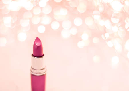 Cosmetic branding, sale and glamour concept - Pink lipstick on rose gold Christmas, New Years and Valentines Day holiday glitter background, make-up and cosmetics product for luxury beauty brandの写真素材