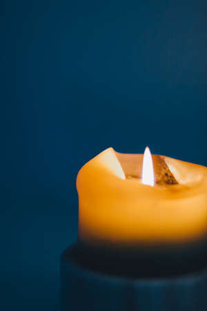 Happy holidays, greeting card backdrop and winter season concept - Yellow holiday candle on blue background, luxury branding design and decoration for Christmas, New Years Eve and Valentines Dayの写真素材