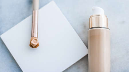 Cosmetic branding, glamour and skincare concept - Makeup foundation bottle and contouring brush on marble, make-up concealer bb cream as cosmetics product for luxury beauty brand holiday designの写真素材