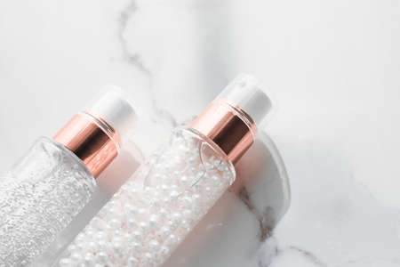 Cosmetic branding, packaging and make-up concept - Skin care serum and gel bottle, moisturizing lotion and lifting cream emulsion on marble, anti-age cosmetics for luxury beauty skincare brand designの写真素材
