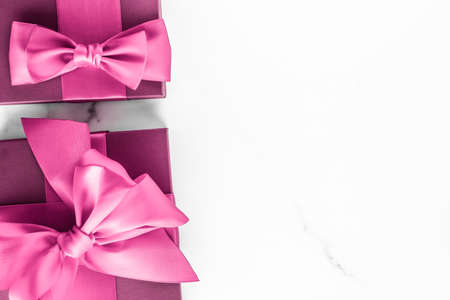 Birthday, wedding and girly branding concept - Pink gift box with silk bow on marble background, girl baby shower present and glamour fashion gift for luxury beauty brand, holiday flatlay art designの写真素材