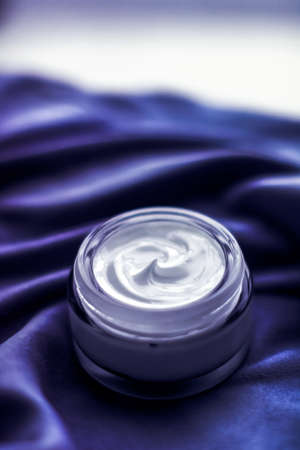 Cosmetic branding, moisturizing emulsion and facial care concept - Luxury face cream moisturizer for sensitive skin, spa cosmetics and natural skincare product as beauty brand holiday gift on purpleの写真素材