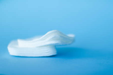 Cosmetology, cleanliness and branding concept - Organic cotton pads on blue background, cosmetics and make-up remover, hygiene and skincare beauty brand product for healthcare and medical designの写真素材