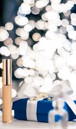 Cosmetic branding, Christmas glitter and girly blog concept - Holiday make-up foundation base, concealer and blue gift box, luxury cosmetics present and blank label products for beauty brand designの写真素材