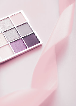 Cosmetic branding, mua and girly concept - Eyeshadow palette and make-up brush on blush pink background, eye shadows cosmetics product as luxury beauty brand promotion and holiday fashion blog designの写真素材