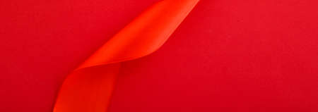 Branding, holidays and luxe brands concept - Abstract curly silk ribbon on red background, exclusive...