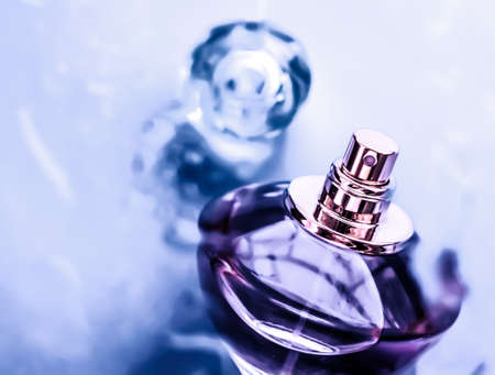 Perfumery, cosmetics and branding concept - Perfume bottle under purple water, fresh sea coastal scent as glamour fragrance and eau de parfum product as holiday gift, luxury beauty spa brand presentの写真素材