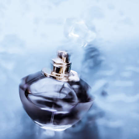 Perfumery, cosmetics and branding concept - Perfume bottle under blue water, fresh sea coastal scent...