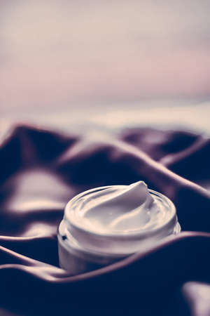 Moisturizing cosmetics, luxe body care and organic science concept - Beauty face cream moisturizer for sensitive skin, luxury spa cosmetic and natural clean skincare product on dark silk fabricの写真素材