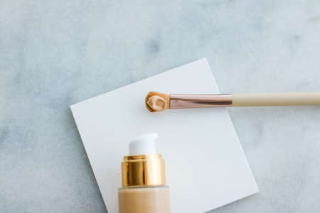 Cosmetic branding, glamour and skincare concept - Makeup foundation bottle and contouring brush on marble, make-up concealer bb cream as cosmetics product for luxury beauty brand holiday designの写真素材