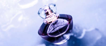 Perfumery, cosmetics and branding concept - Perfume bottle under purple water, fresh sea coastal...