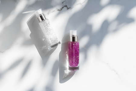 Cosmetic branding, packaging and make-up concept - Skin care serum and gel bottle, moisturizing lotion and lifting cream emulsion on marble, anti-age cosmetics for luxury beauty skincare brand designの写真素材