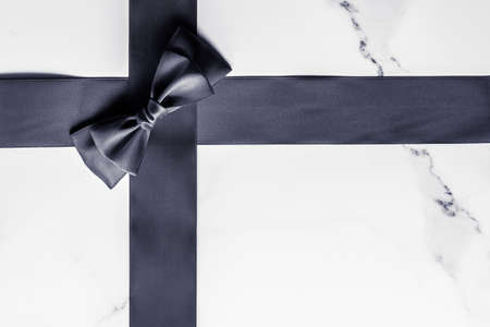Holiday gift, decoration and sale promotion concept - Black silk ribbon and bow on marble...