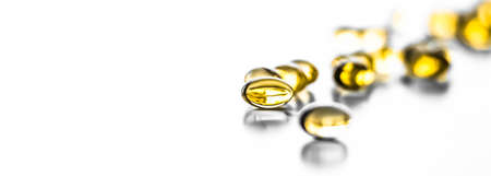 Pharmaceutical, branding and science concept -  Vitamin D and golden Omega 3 pills for healthy diet nutrition, fish oil food supplement pill capsules, healthcare and medicine as pharmacy backgroundの写真素材