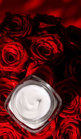 Anti-age moisturizer, luxe cosmetics and organic science concept - Moisturizing beauty face cream for sensitive skin and red roses flowers, luxury clean skincare cosmetics on floral backgroundの写真素材