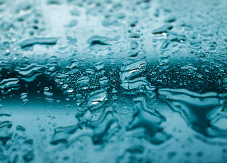 Liquid, wet and zen concept - Water texture abstract background, aqua drops on turquoise glass as science macro element, rainy weather and nature surface art backdrop for environmental brand designの写真素材
