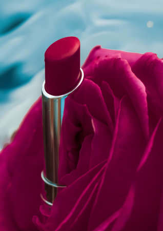 Cosmetic branding, luxe and fashion concept - Pink lipstick and rose flower on liquid background, waterproof glamour make-up and lip gloss cosmetics product for luxury beauty brand holiday designの写真素材