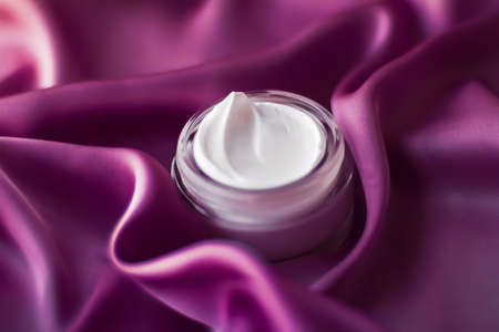 Moisturizing cosmetics, luxe body care and organic science concept - Beauty face cream moisturizer for sensitive skin, luxury spa cosmetic and natural clean skincare product on purple silk fabricの写真素材