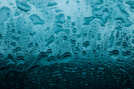 Liquid, wet and zen concept - Water texture abstract background, aqua drops on turquoise glass as science macro element, rainy weather and nature surface art backdrop for environmental brand designの写真素材