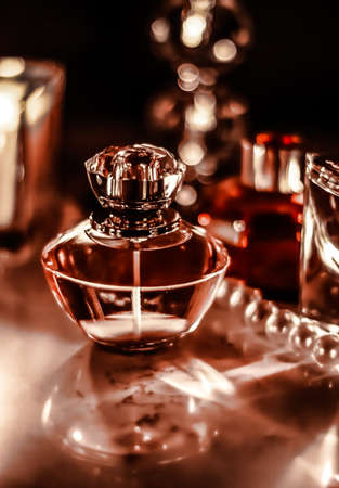Perfumery, cosmetics branding and luxe concept - Perfume bottle and vintage fragrance on glamour vanity table at night, pearls jewellery and eau de parfum as holiday gift, luxury beauty brand presentの写真素材