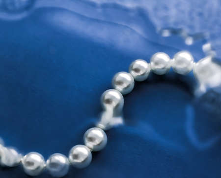Jewelry, branding and gems concept - Coastal jewellery fashion, pearl necklace under blue water background, glamour style present and chic gift for luxury jewelery brand, holiday banner designの写真素材