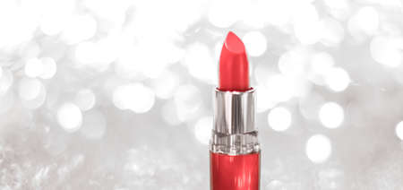 Cosmetic branding, sale and glamour concept - Coral lipstick on silver Christmas, New Years and Valentines Day holiday glitter background, make-up and cosmetics product for luxury beauty brandの写真素材