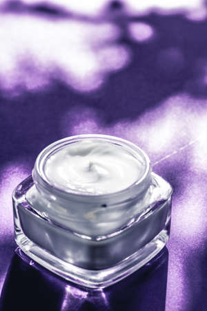 Luxe cosmetics, anti-age moisturizer and organic science concept - Beauty face cream for sensitive skin, moisturizing luxury spa cosmetic and natural complexion skincare product on purple backgroundの写真素材