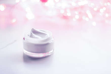 Cosmetic branding, gift and spa concept - Facial cream moisturizer jar on holiday glitter background, moisturizing skin care as lifting emulsion, anti-age cosmetics for luxury beauty skincare brandの写真素材