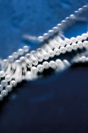 Jewelry, branding and gems concept - Coastal jewellery fashion, pearl necklace under blue water...