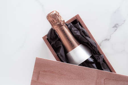 Celebration, drink and branding concept - Champagne bottle and gift box on marble, New Years, Christmas, Valentines Day or wedding holiday present and luxury product packaging for beverage brandの写真素材