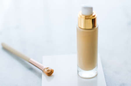 Cosmetic branding, glamour and skincare concept - Makeup foundation bottle and contouring brush on marble, make-up concealer bb cream as cosmetics product for luxury beauty brand holiday designの写真素材