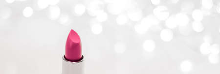 Cosmetic branding, sale and glamour concept - Pink lipstick on silver Christmas, New Years and Valentines Day holiday glitter background, make-up and cosmetics product for luxury beauty brandの写真素材