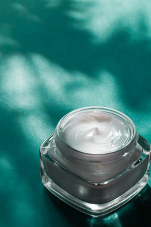 Luxe cosmetics, anti-age moisturizer and organic science concept - Beauty face cream for sensitive skin, moisturizing luxury spa cosmetic and natural complexion skincare product on emerald backgroundの写真素材