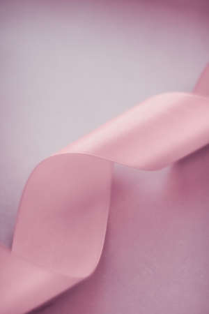 Branding, holidays and luxe brands concept - Abstract silk ribbon on blush pink background,...