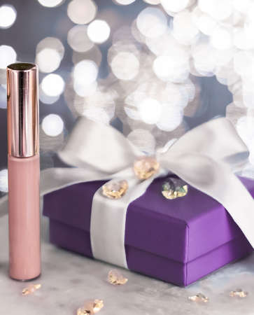 Cosmetic branding, Christmas glitter and girly blog concept - Holiday make-up foundation base, concealer and purple gift box, luxury cosmetics present and blank label products for beauty brand designの写真素材