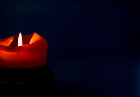 Happy holidays, greeting card backdrop and winter season concept - Red holiday candle on dark background, luxury branding design and decoration for Christmas, New Years Eve and Valentines Dayの写真素材