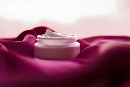Cosmetic branding, toiletries and spa concept - Face cream moisturizer jar on silk background, moisturizing skin care lotion and lifting emulsion, anti-age cosmetics for luxury beauty skincare brandの写真素材