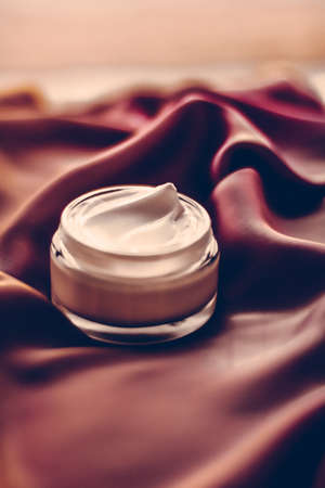 Moisturizing cosmetics, luxe body care and organic science concept - Beauty face cream moisturizer for sensitive skin, luxury spa cosmetic and natural clean skincare product on chocolate silk fabricの写真素材
