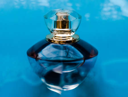 Perfumery, cosmetics and branding concept - Perfume bottle under blue water, fresh sea coastal scent as glamour fragrance and eau de parfum product as holiday gift, luxury beauty spa brand presentの写真素材